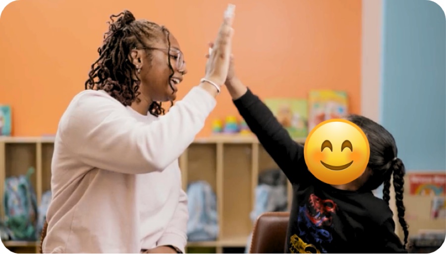 Therapist giving a child a big high five